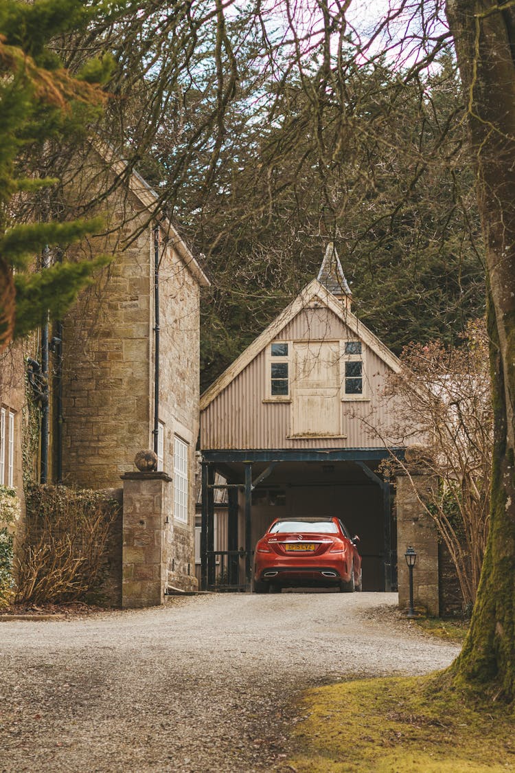 Red Car Parked At Garage