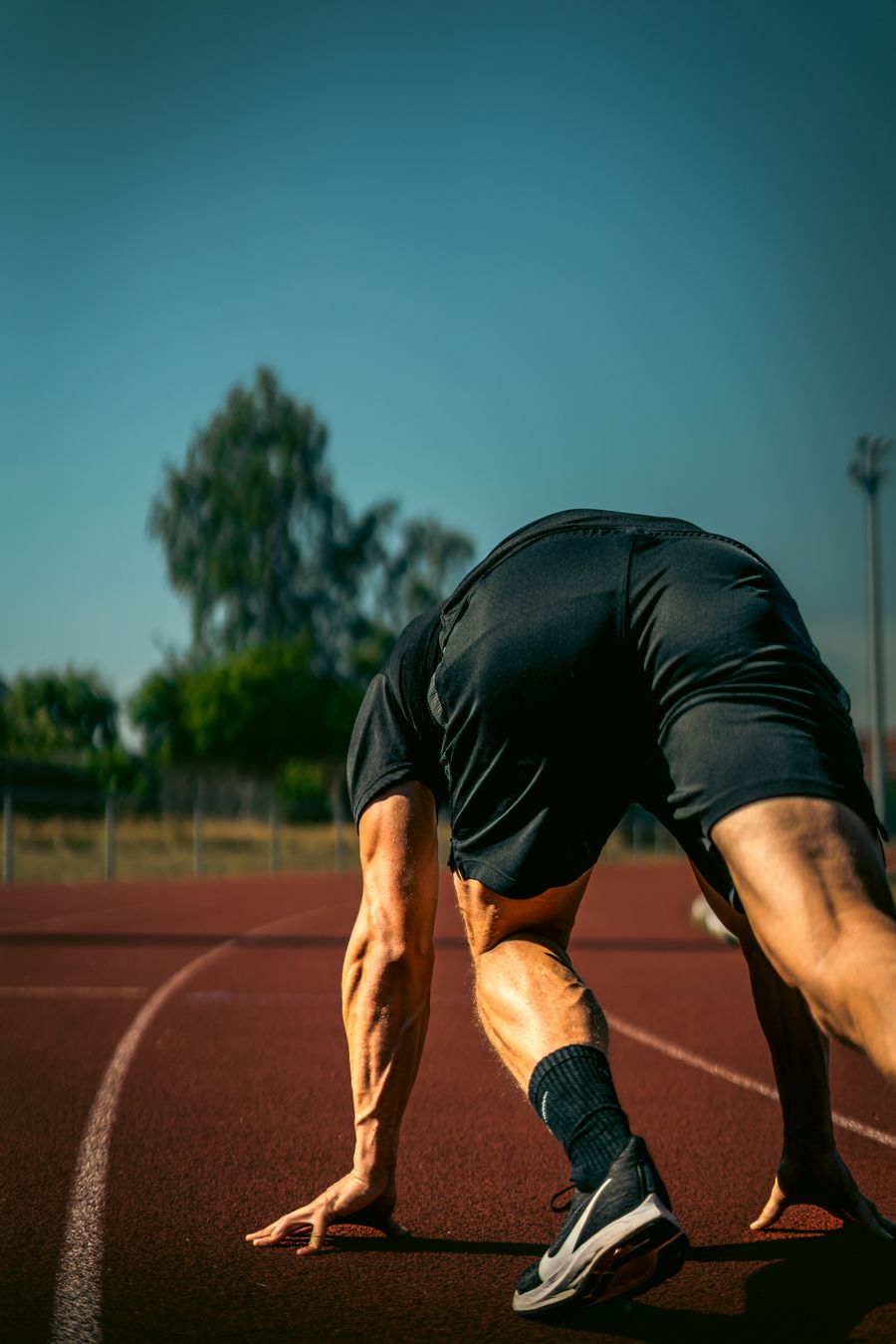 Sprinter setting off from the blocks on an outdoor track — Thomas Ronveaux on Pexels