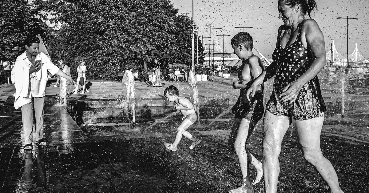 A lively moment captures a family enjoying a summer splash park outdoors.