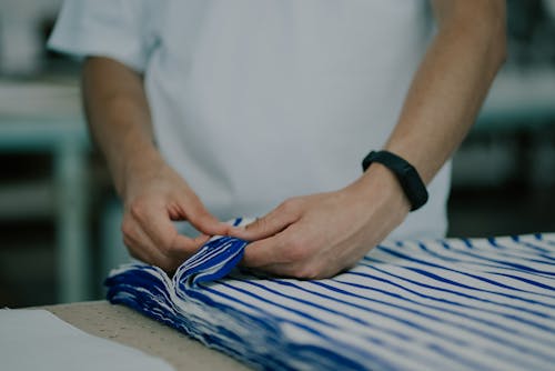 A Person Holding Blue and White Cloth