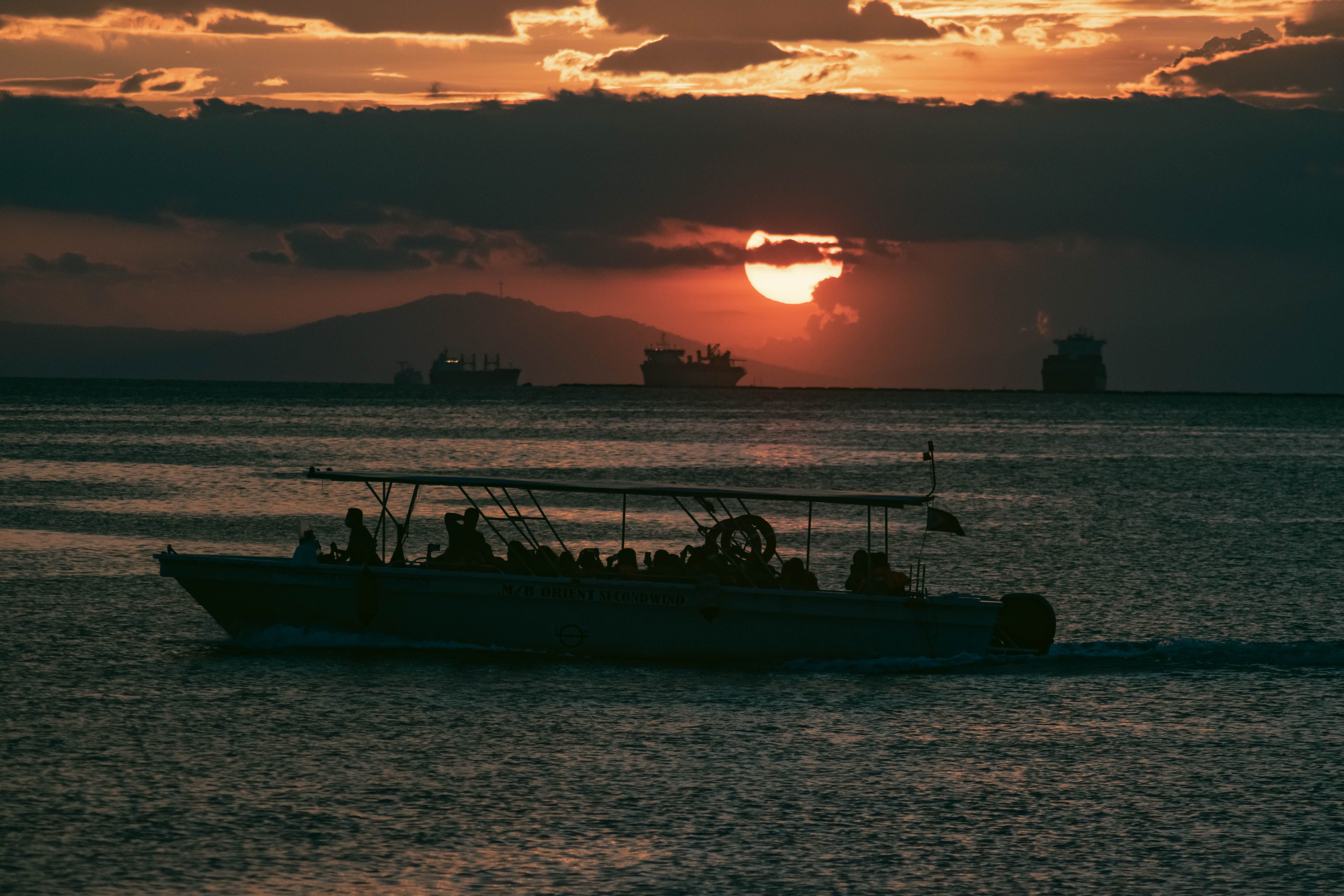 Silhouette of People Riding Boat on Sea During Sunset · Free Stock Photo