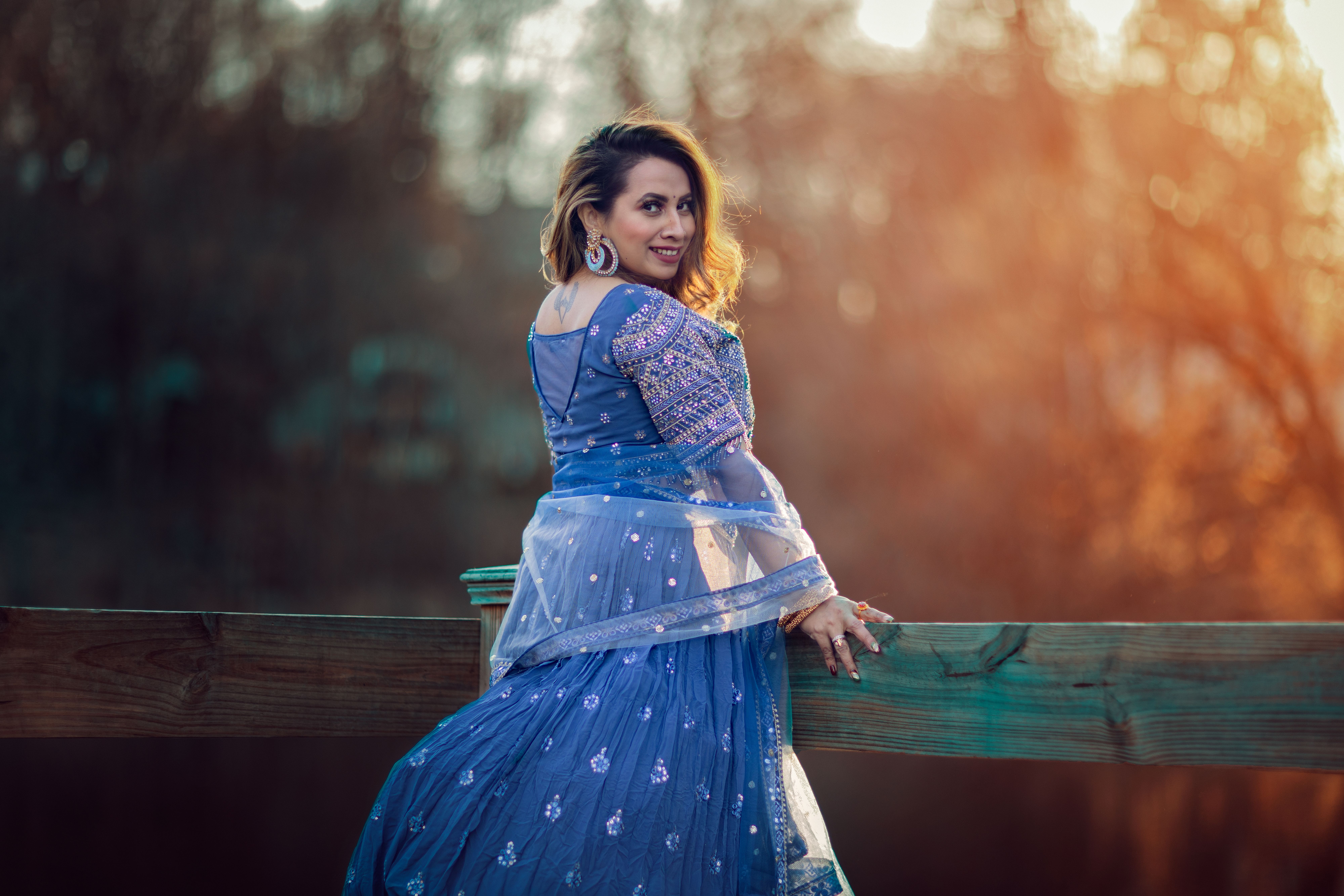 Smiling Woman in Traditional Dress on Sunset · Free Stock Photo