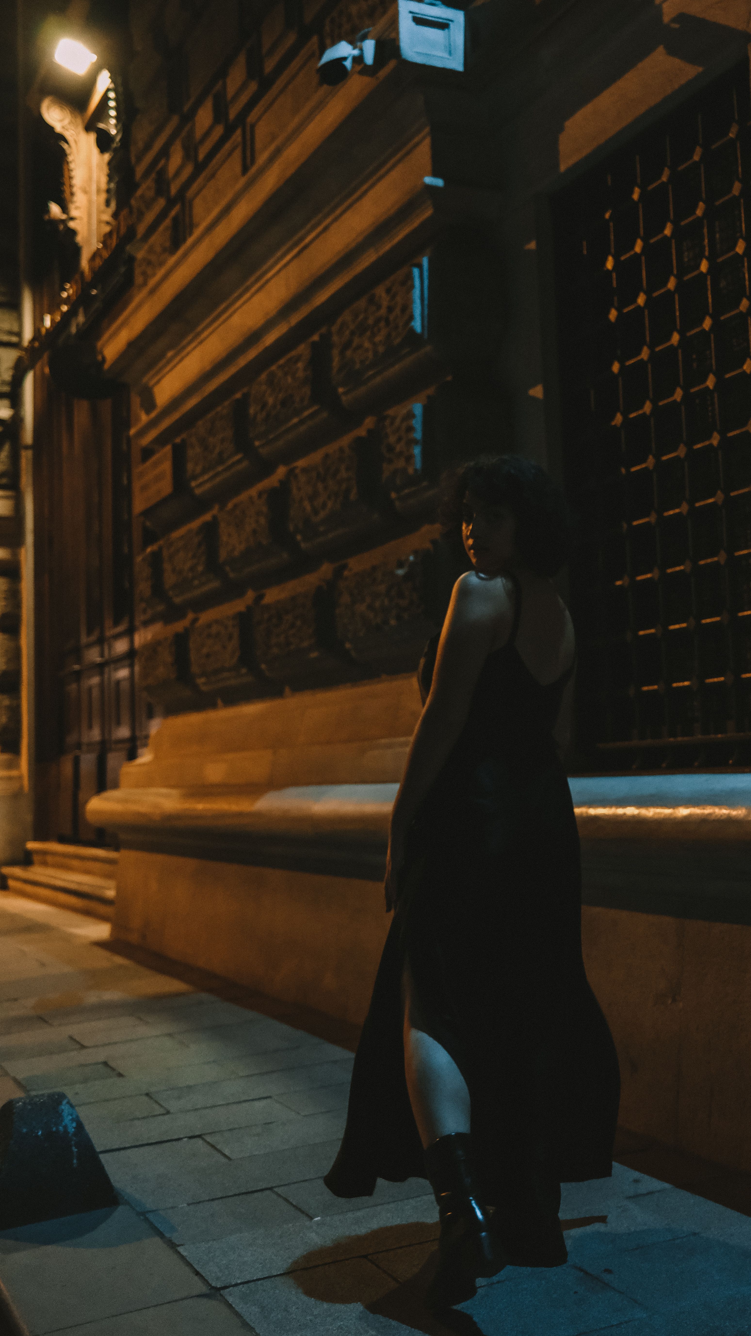 A Woman in Black Dress Standing on the Street at Night · Free Stock Photo