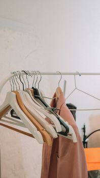 Elegant blazers hanging on a modern clothes rack indoors, perfect for fashion and retail themes.