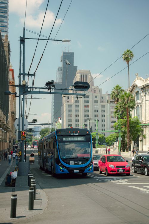 Free Cityscape with blue bus and cars on a sunny day. Stock Photo