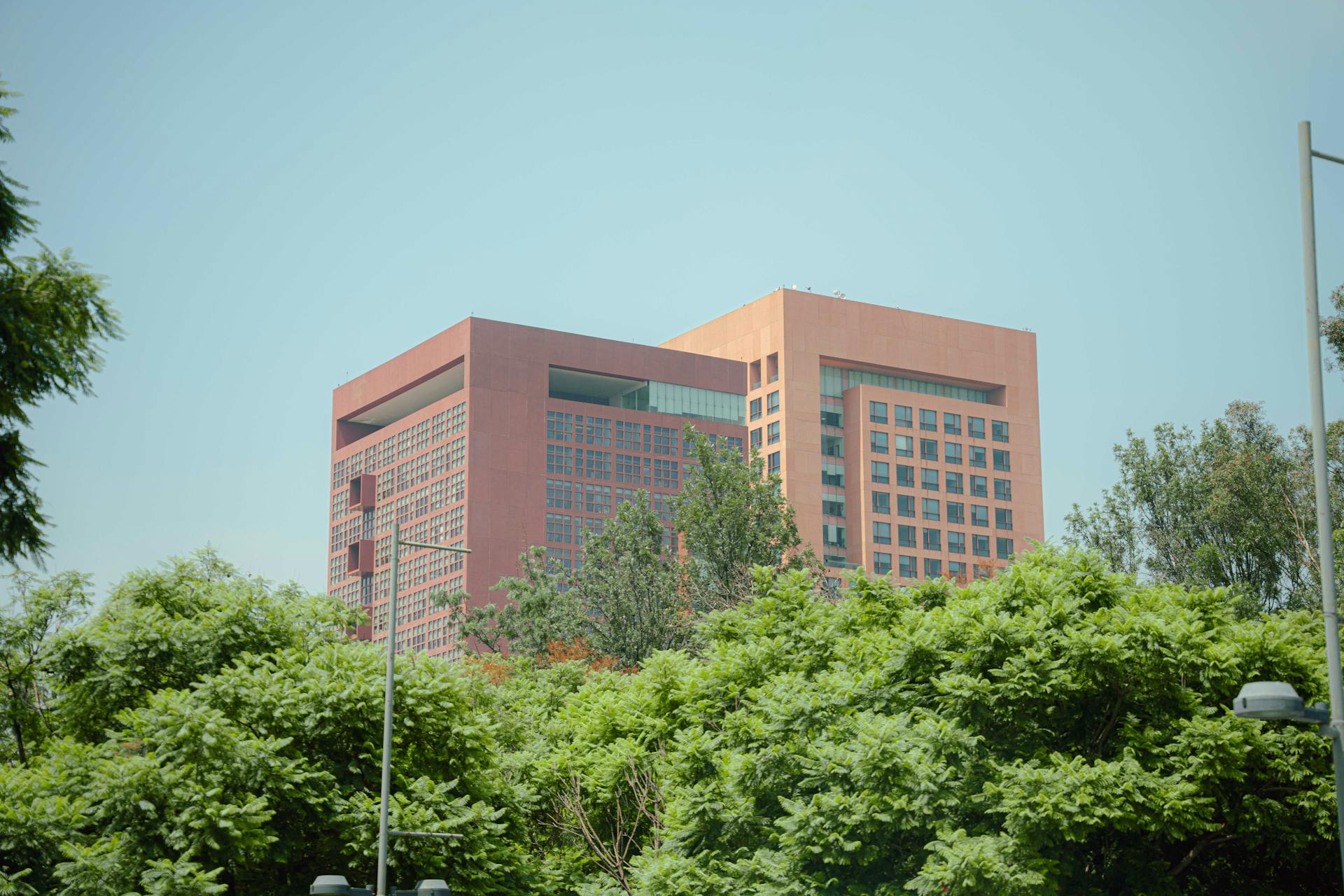 Contemporary architecture of a Mexican government building surrounded by greenery.