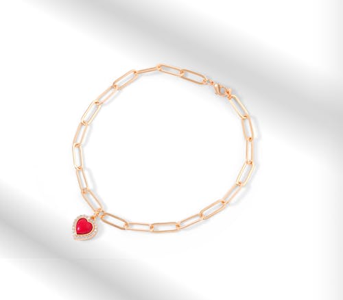 
Gold Bracelet with Red Heart Shaped Stone