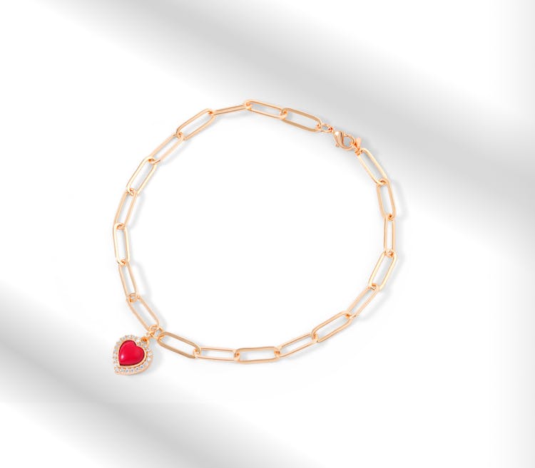 
Gold Bracelet With Red Heart Shaped Stone