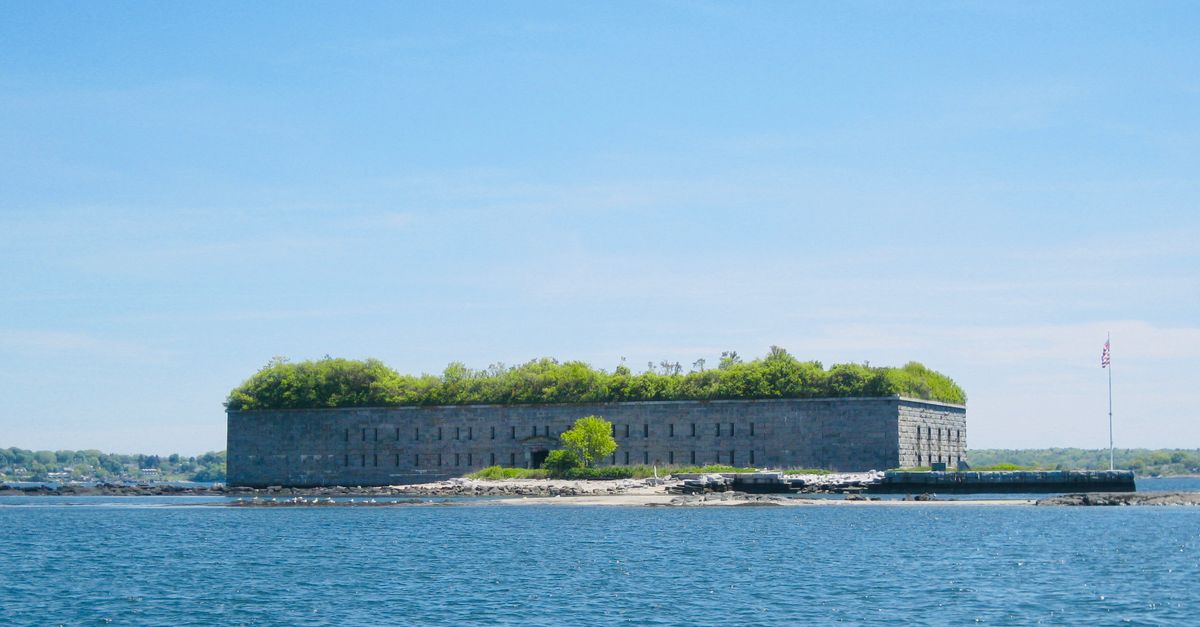 Scenic view of Fort Gorges with blue sky and water in Portland, Maine.