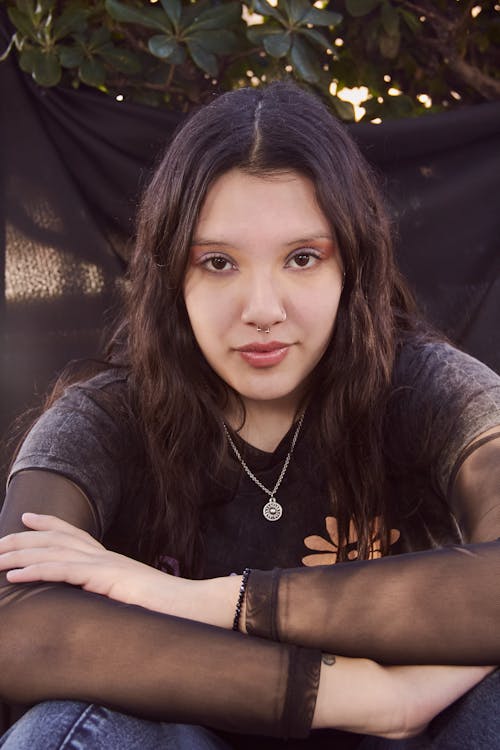 A Woman in Black Shirt Looking at the Camera