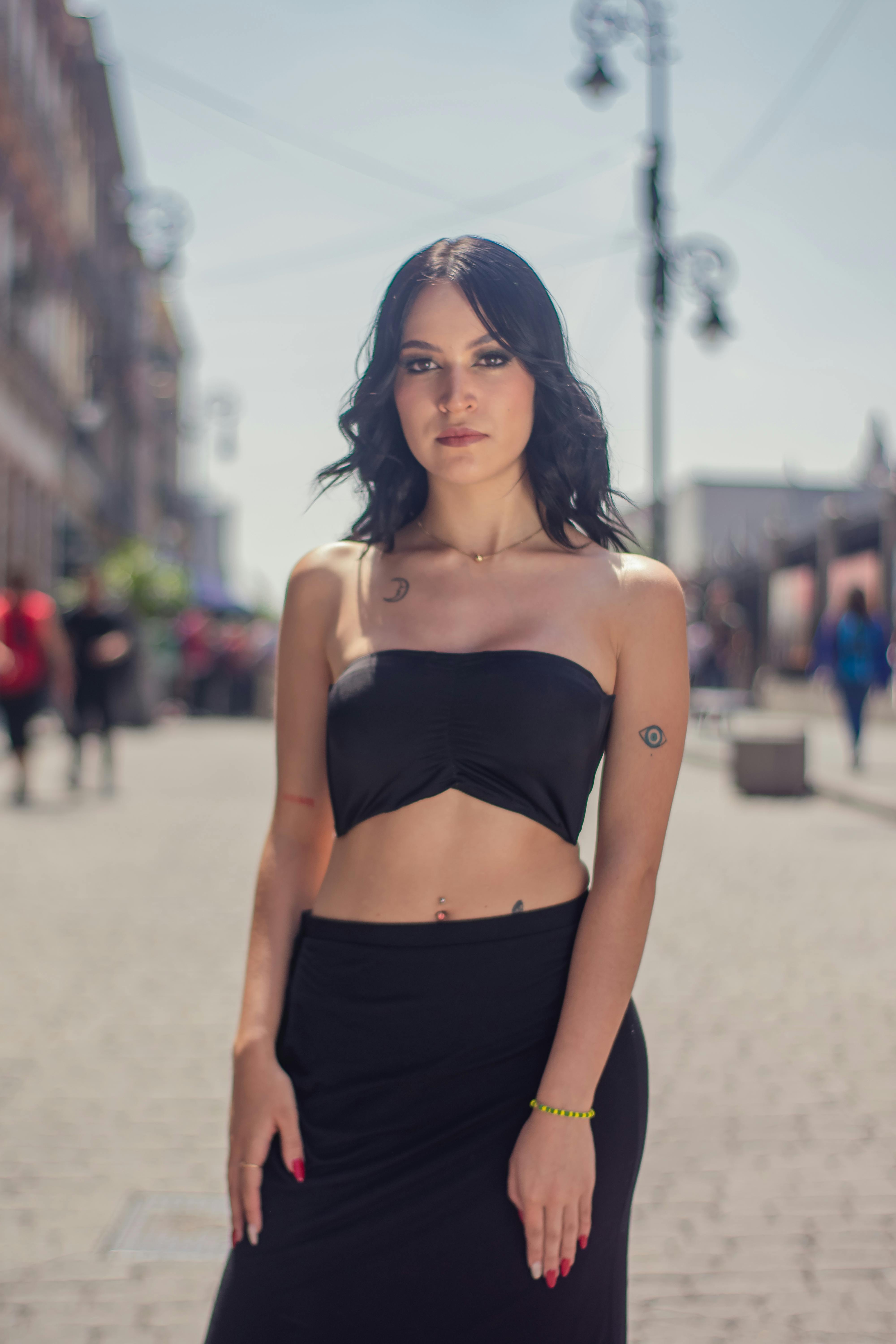 a woman in black tube top and black skirt