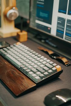 Close-up of a mechanical keyboard on a modern workspace desk with wood accents.