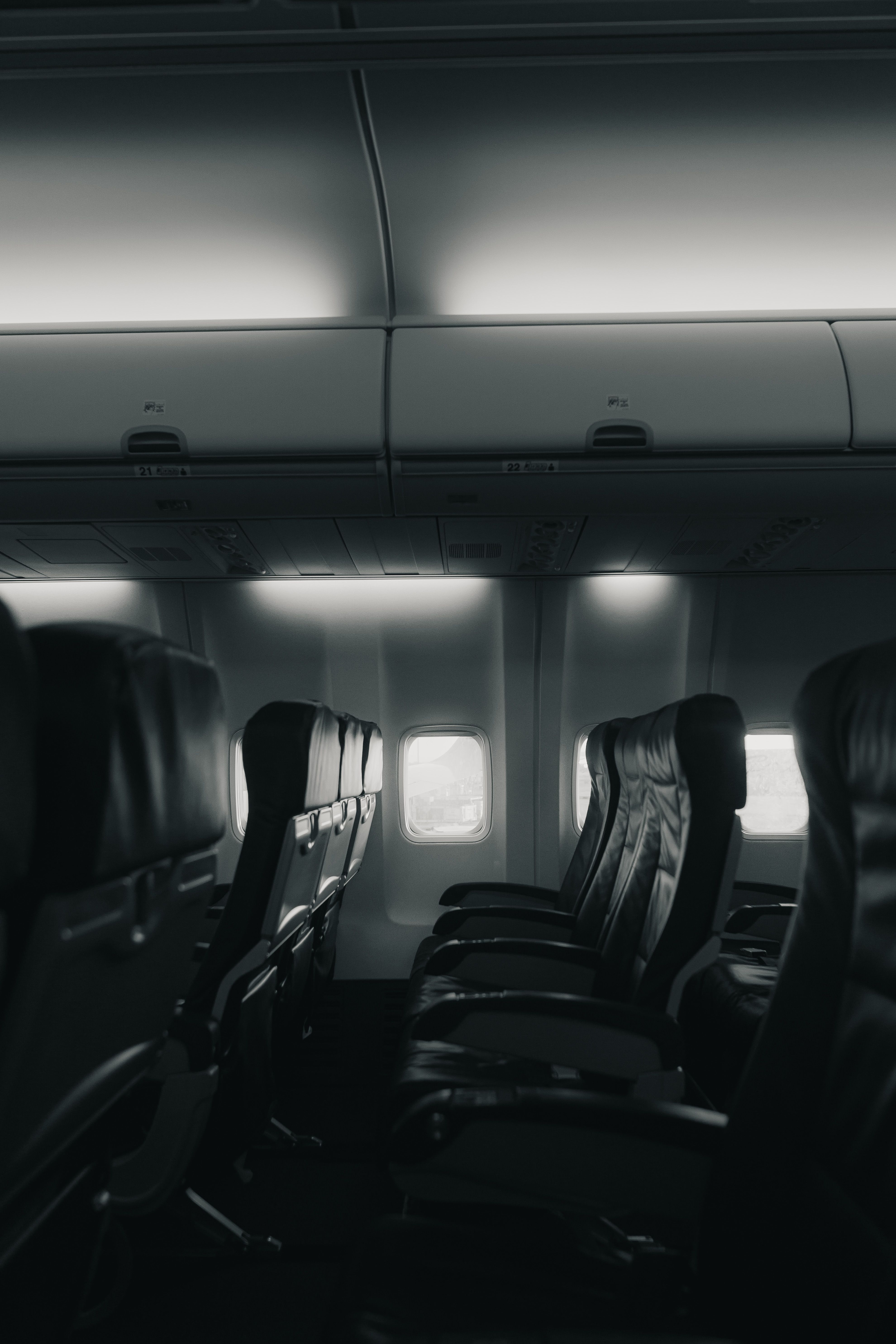 Grayscale Photo of Empty Airplane Seats · Free Stock Photo