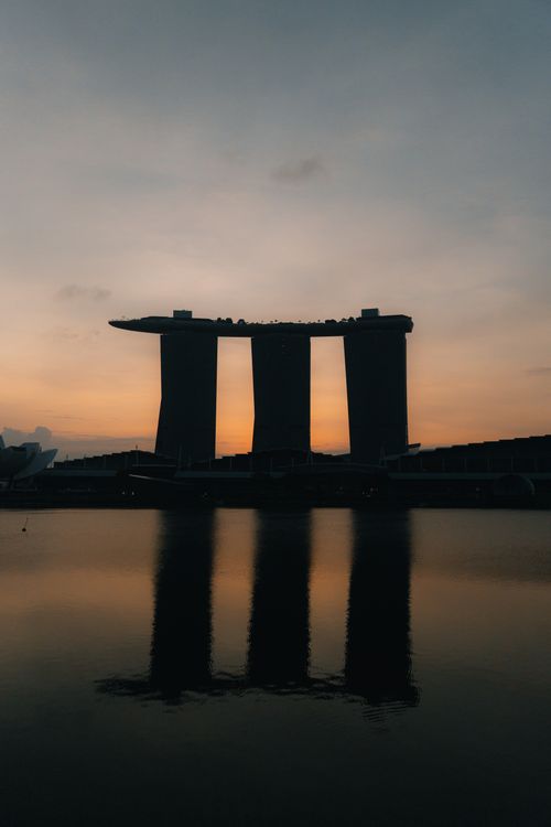 Free Dramatic view of Marina Bay Sands reflected in water during a serene dusk in Singapore. Stock Photo