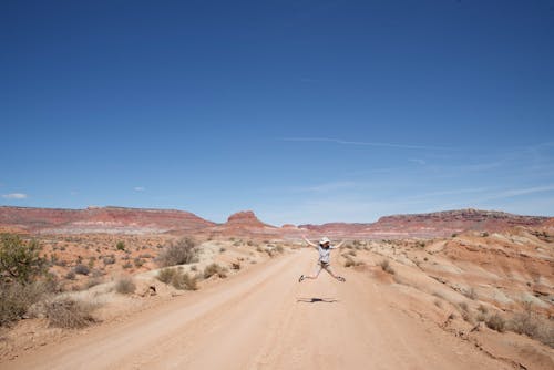 Woman Jumping in the Middle of the Desert