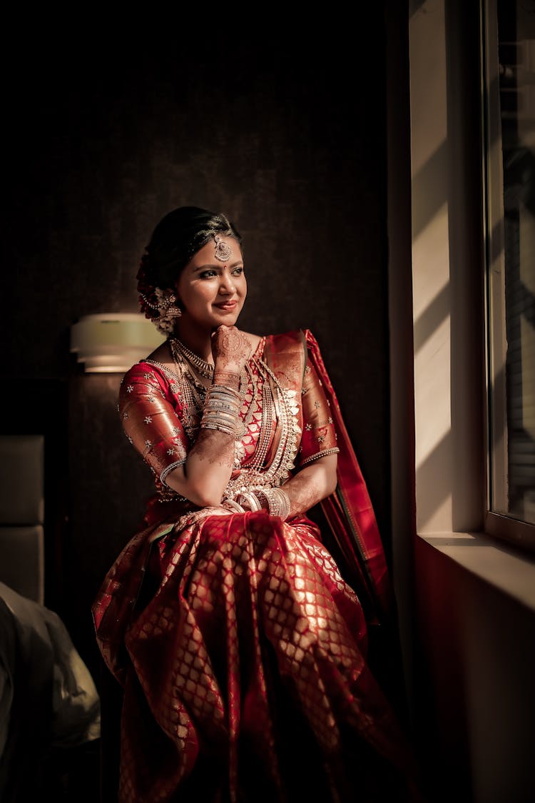 Beautiful Bride In Traditional Clothes Looking In Window