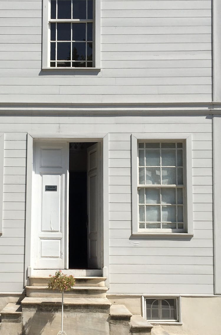 White Building Facade With Open Doors