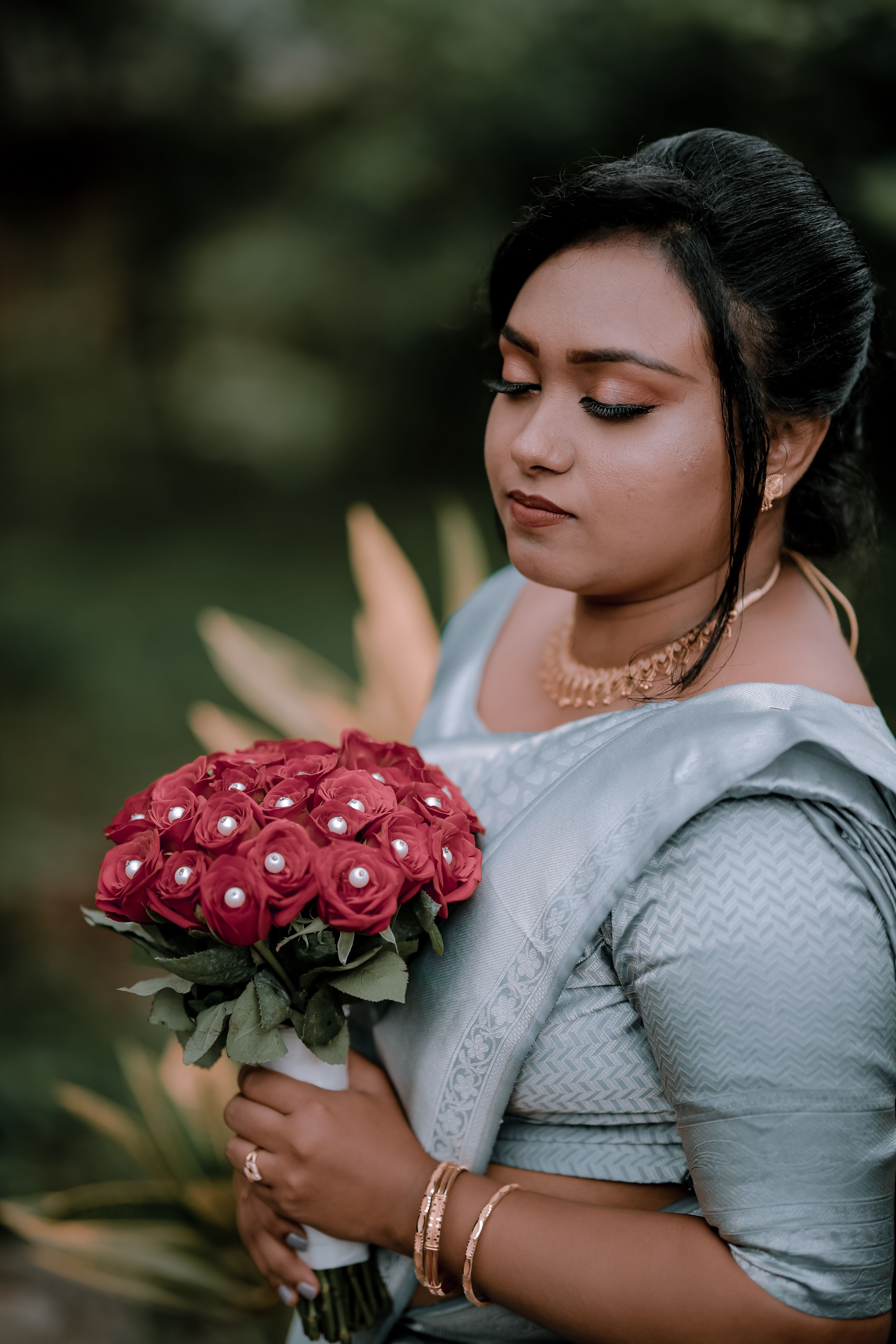 A Woman Holding a Bouquet of Red Roses · Free Stock Photo