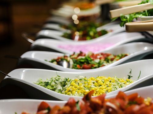 Free A vibrant selection of salads served in elegant ceramic dishes at a buffet. Stock Photo