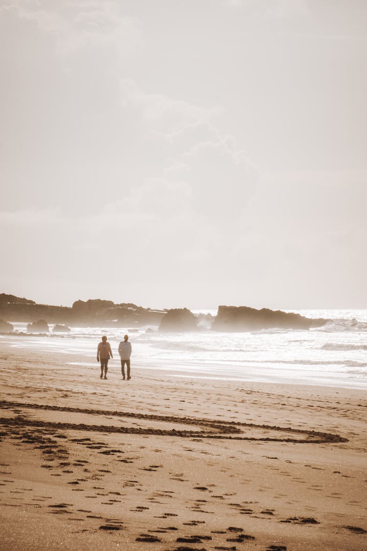 People Walking On Beach On Dawn