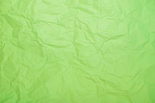 A vibrant green crumpled paper texture ideal for backgrounds and designs.