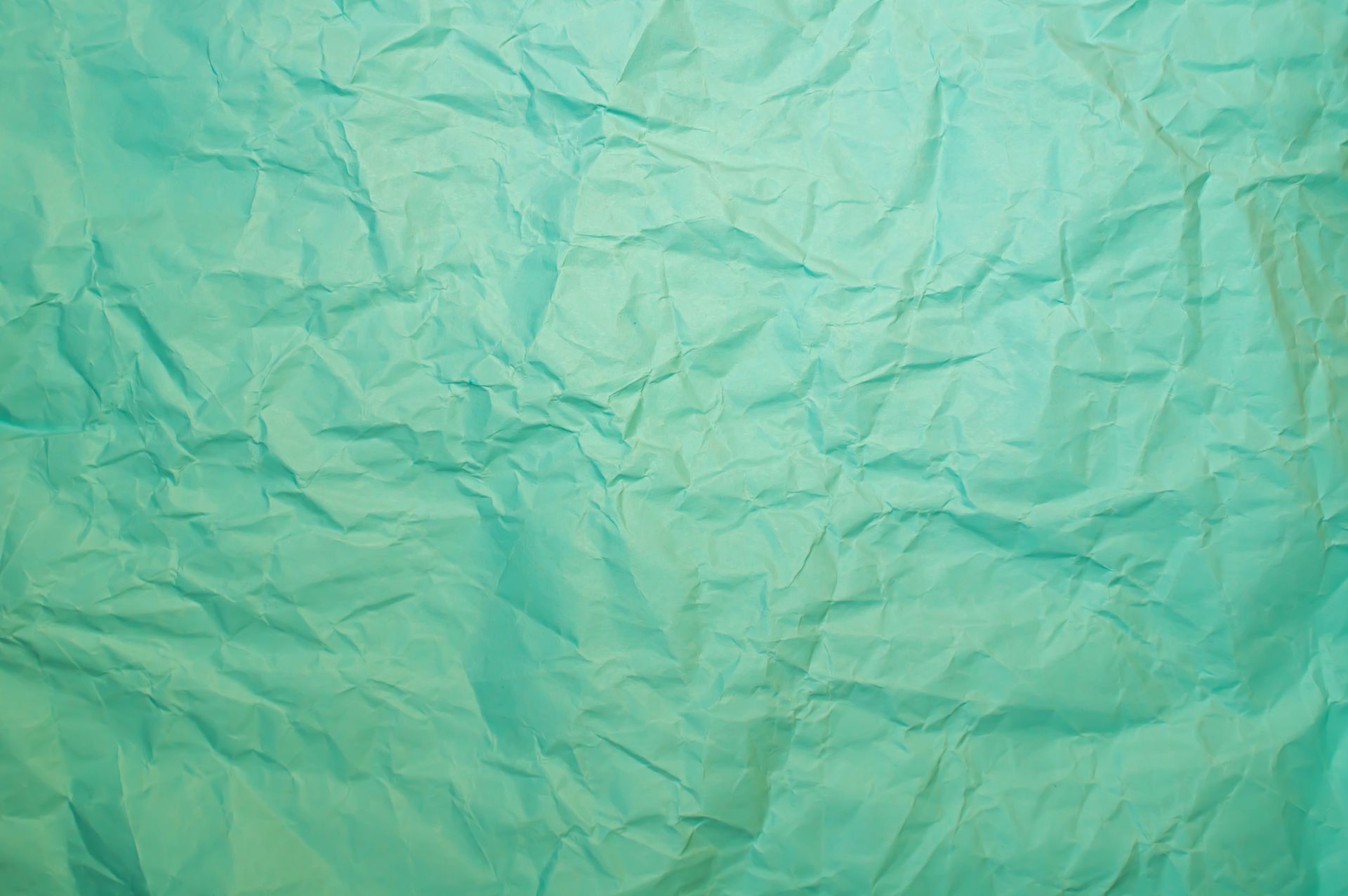 Teal creased paper texture ideal for backgrounds and design projects.