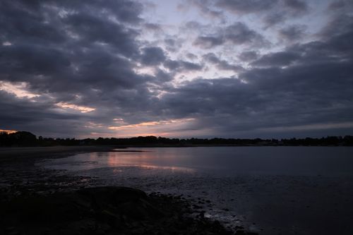 Free Serene twilight scene over Stamford lake with calm waters reflecting a cloudy sky. Stock Photo