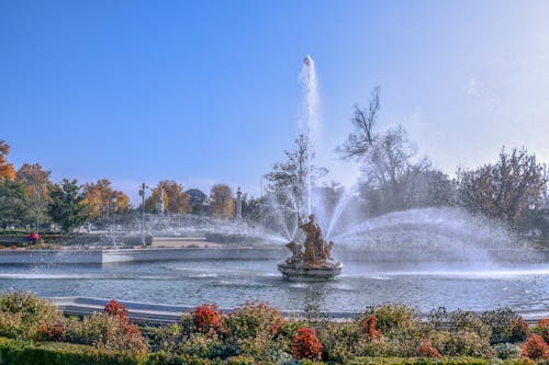 Free Pond with a Fountain in a Garden  Stock Photo