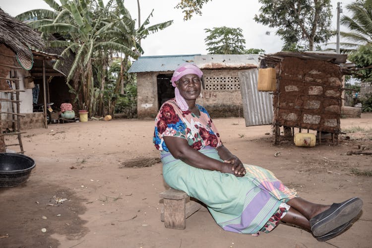 Elderly Woman Sitting On A Farm 