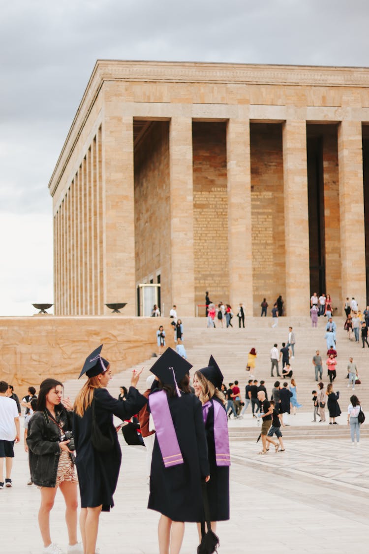 People On Graduation Day In Front Of University