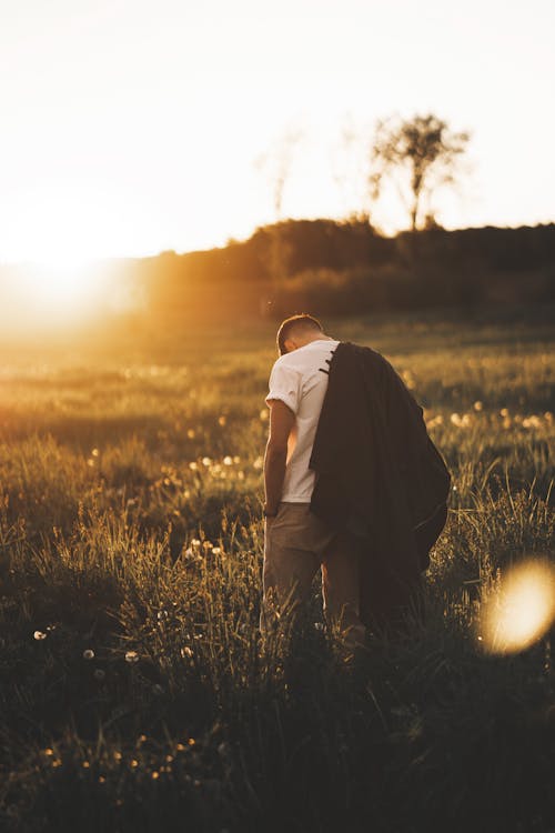 Man in White Shirt Standing in the Field