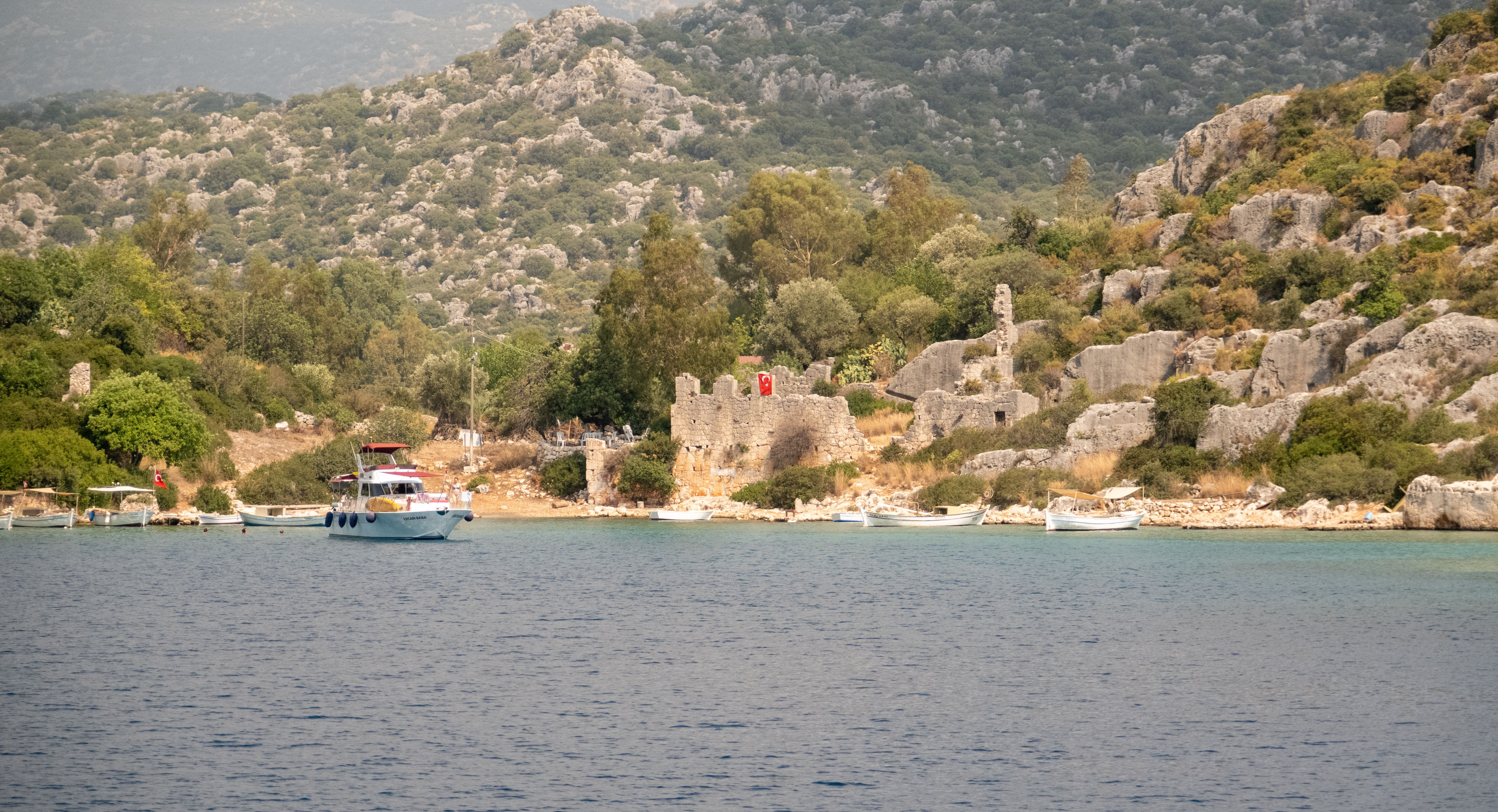 Kekova sunken city Turkey with ancient Lycian ruins partially submerged in crystal-clear turquoise Mediterranean waters under golden sunlight