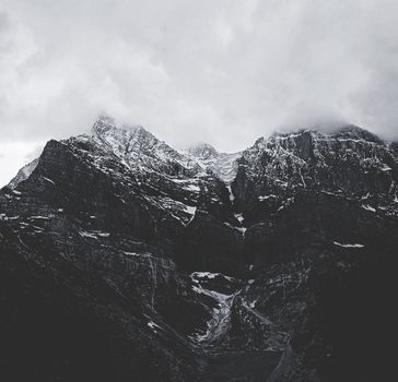 Monochrome photography of majestic snow-covered mountains in Himachal Pradesh, India.