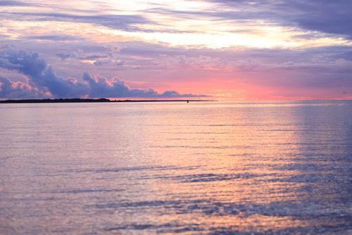 Free Beautiful seascape during sunset with vibrant colors and calm ocean surface. Stock Photo