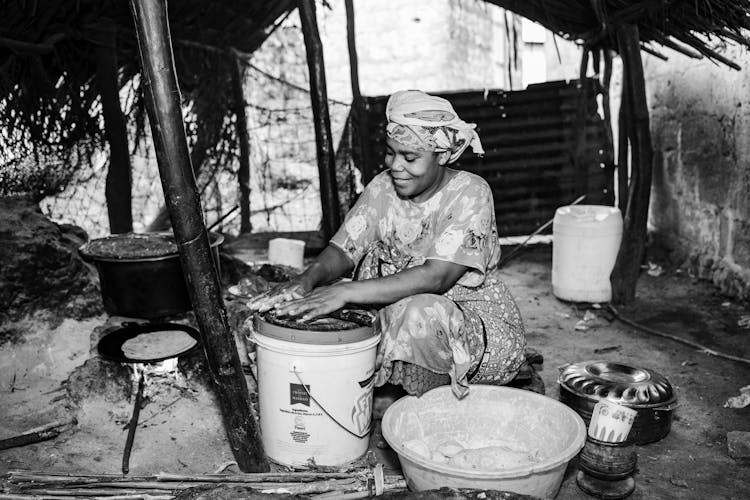 Black And White Photo Of A Woman Cooking 