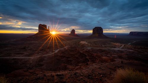 Free Stunning sunset over Monument Valley with iconic rock formations and dramatic sky. Stock Photo