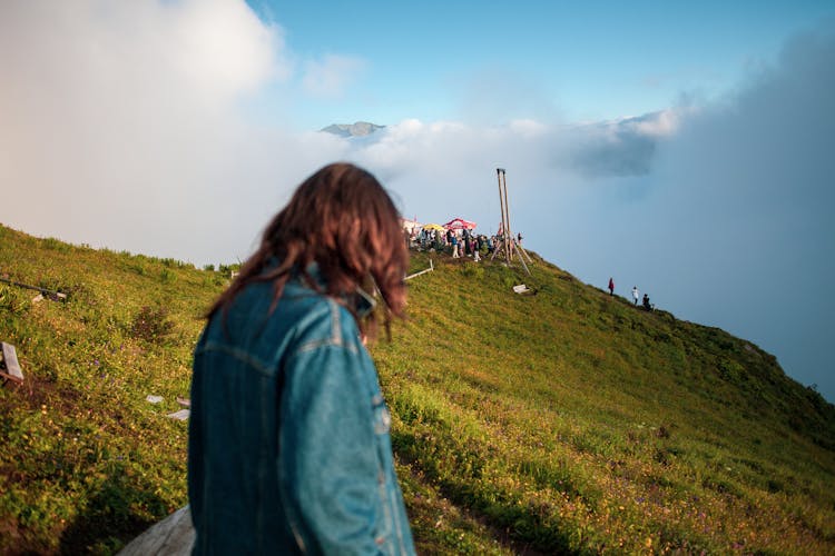 Brunette Woman Looking At Crowd On Hill