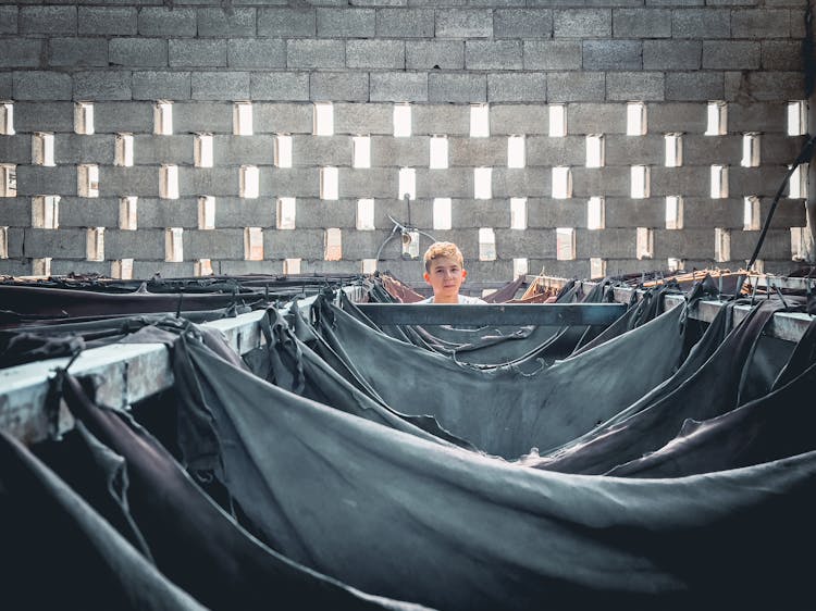 Boy Peeking Over Fabrics