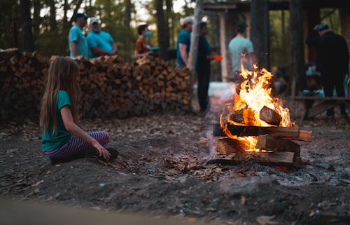 A Girl Sitting Beside the Bonfire