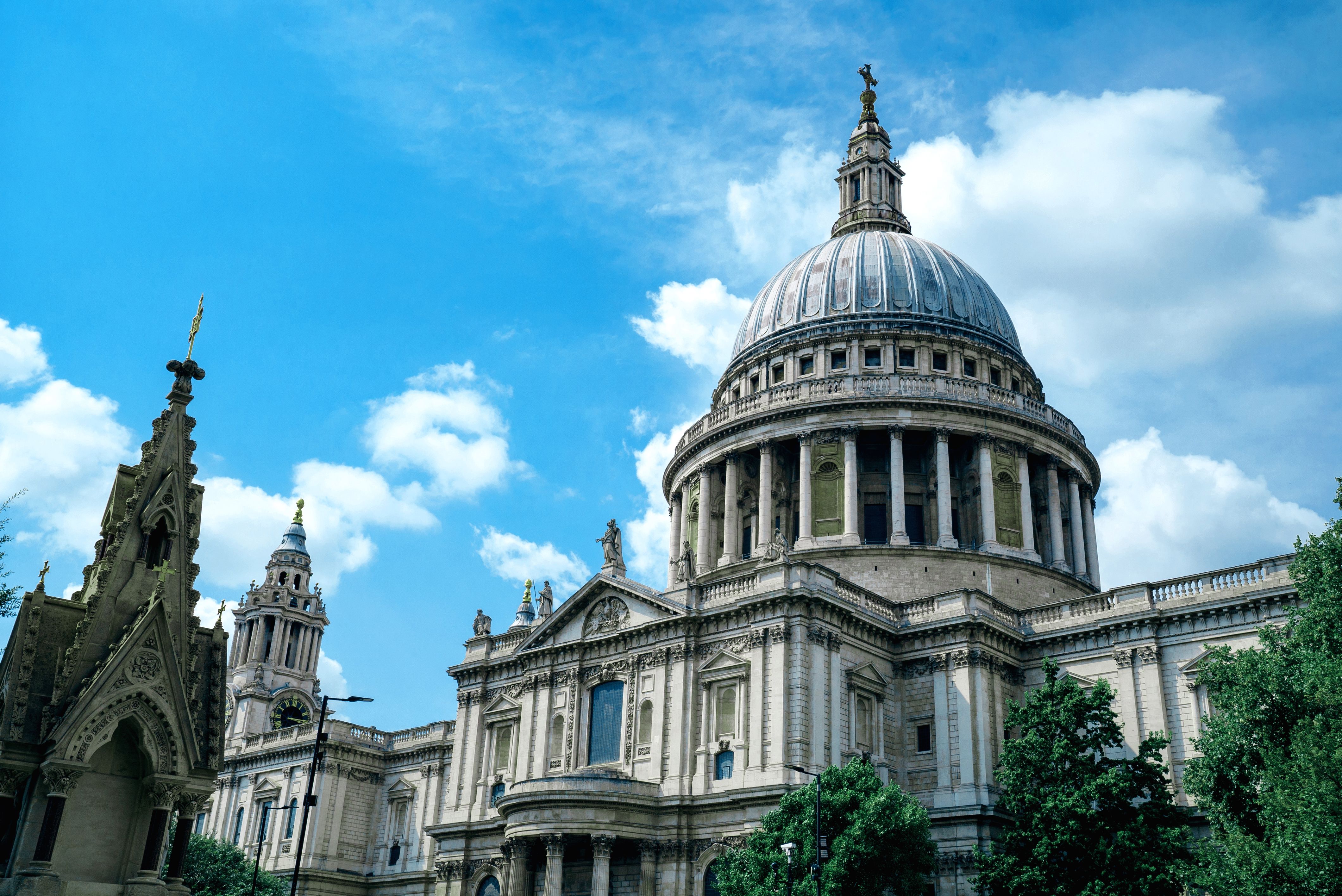 Stunning view of St Paul's Cathedral's dome against a bright blue sky, showcasing iconic architecture in London.
