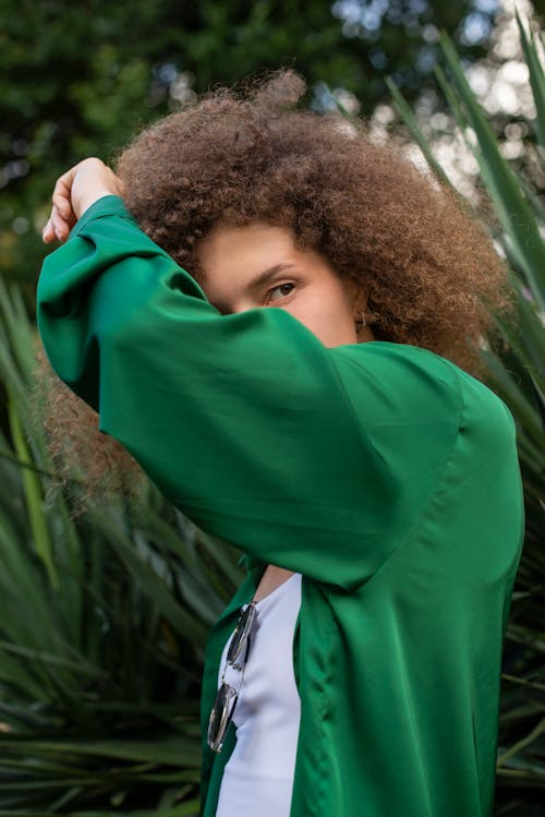 Free Girl in Green Hoodie Covering Her Face With Her Hair Stock Photo
