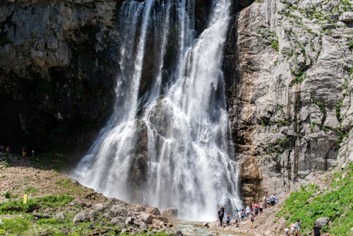 Free People Standing Near Waterfalls Stock Photo