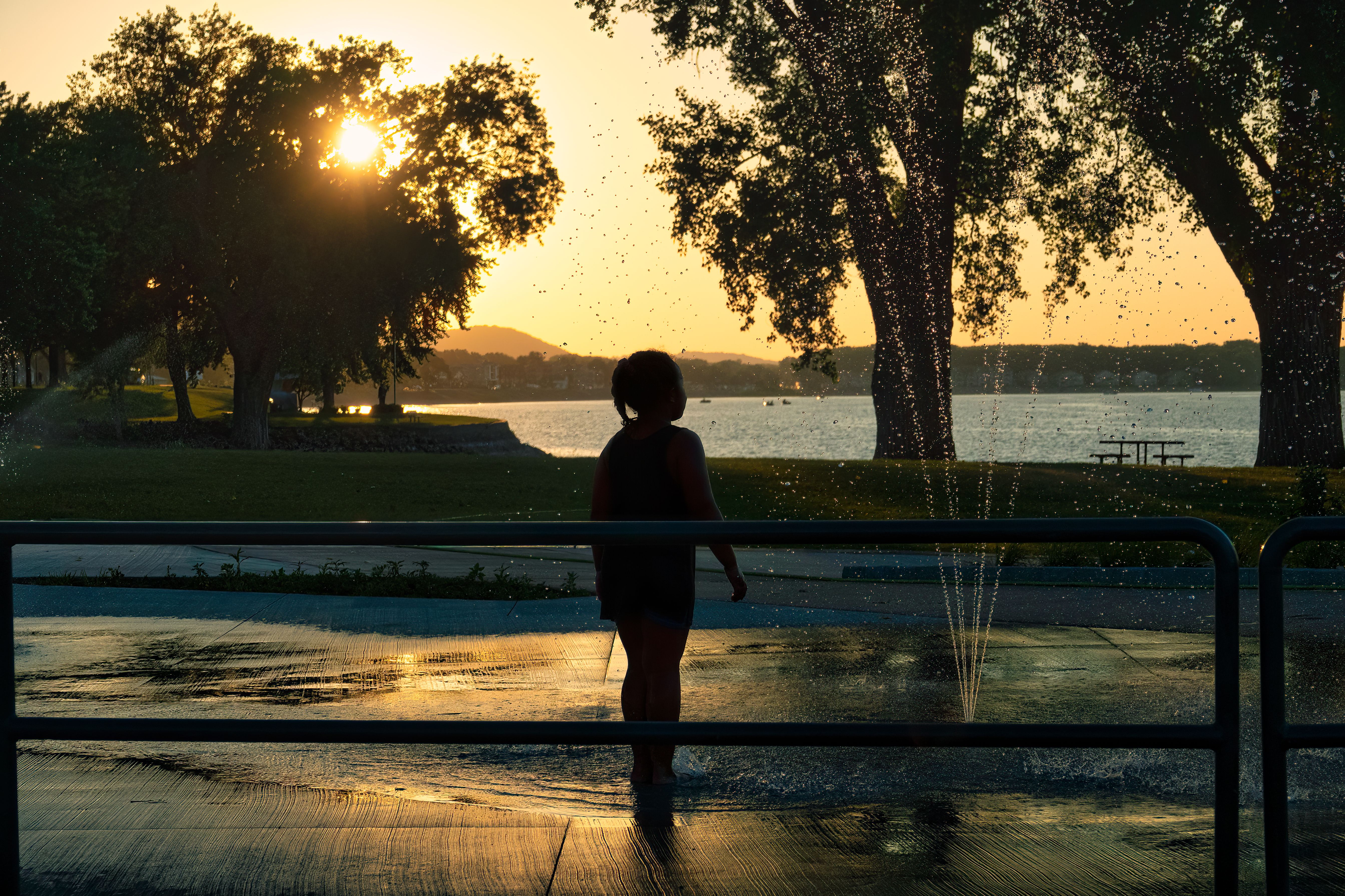 Silhouette of a Girl Standing by the Fountain · Free Stock Photo