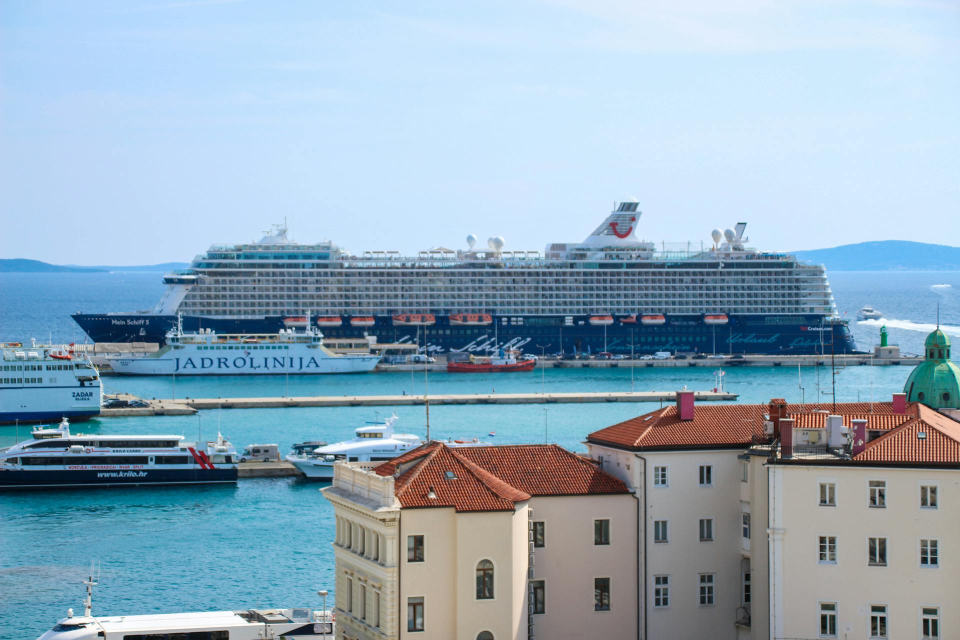 A vibrant scene of majestic cruise ships docked in a picturesque port, perfect for travel dreams.