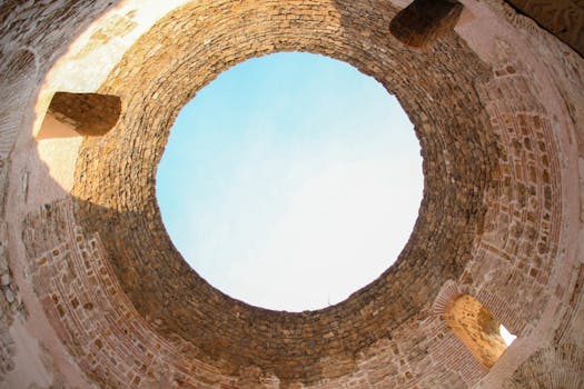 Stunning perspective of a historical stone structure's opening against a blue sky in Croatia.
