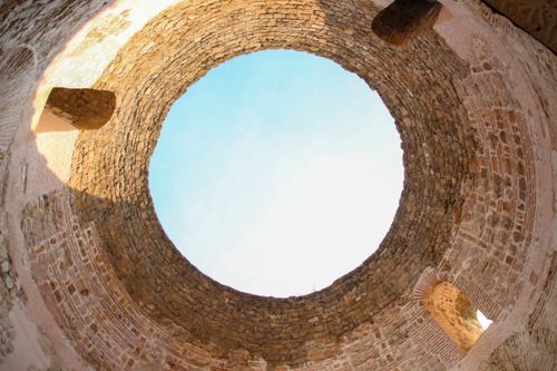 Free Stunning perspective of a historical stone structure's opening against a blue sky in Croatia. Stock Photo