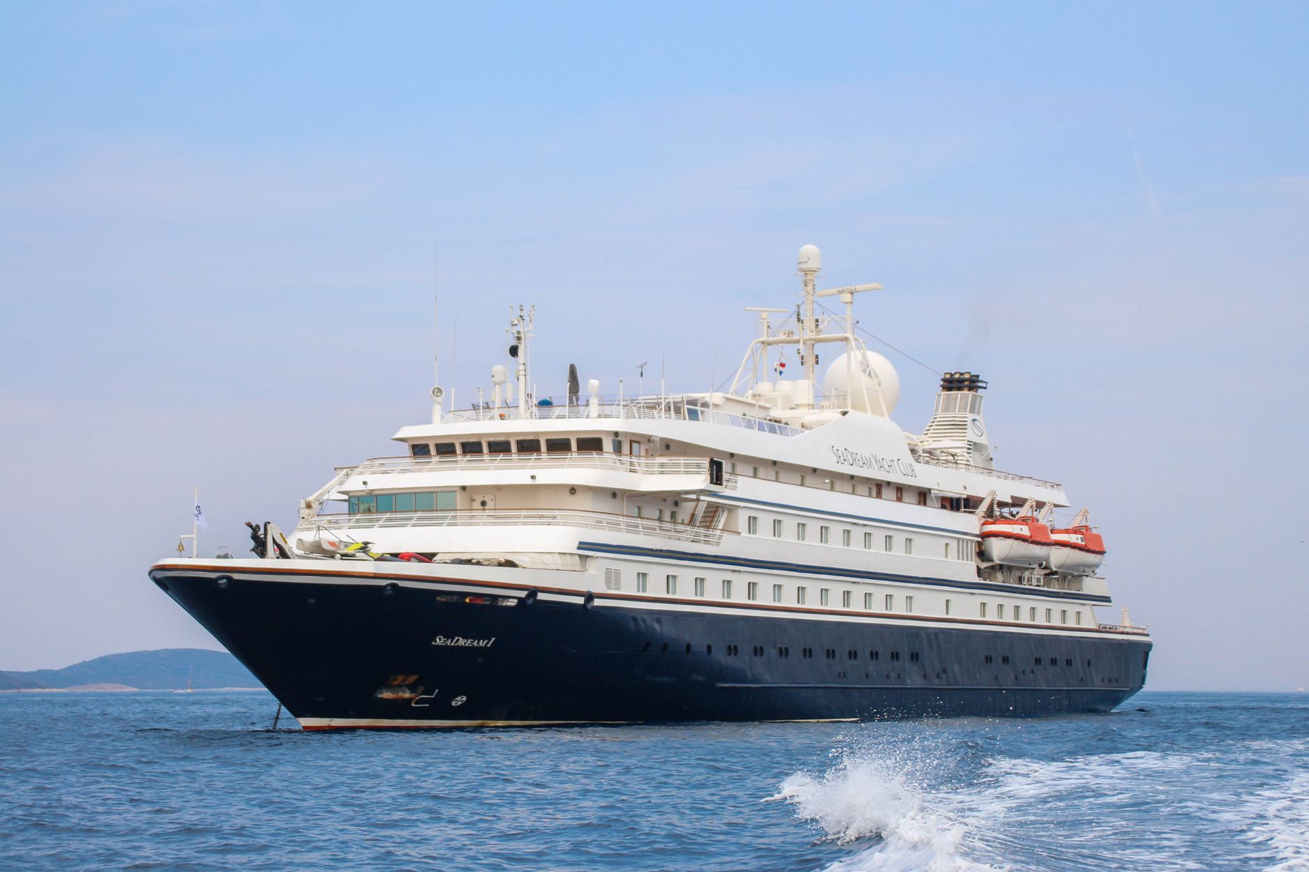 Small ship cruises for couples at sunset on open blue water.