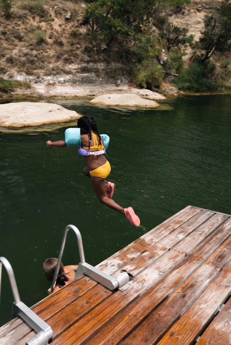 A Child Jumping On The River