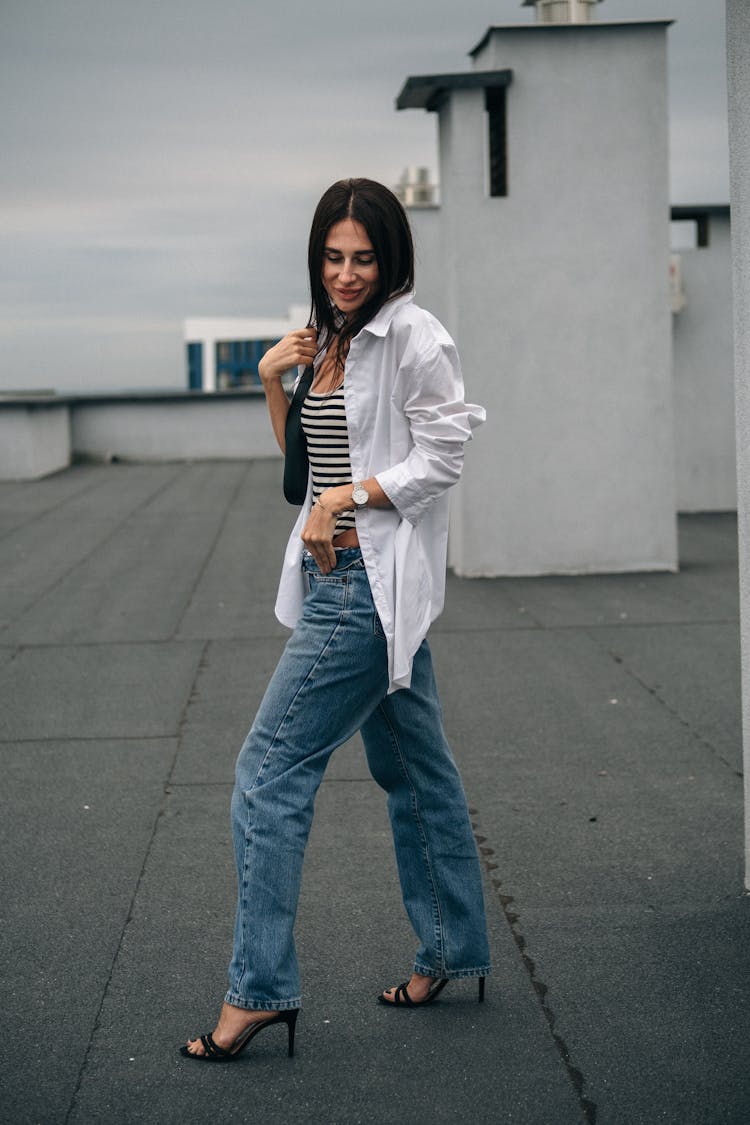 Woman Posing In Jeans And With High Heels