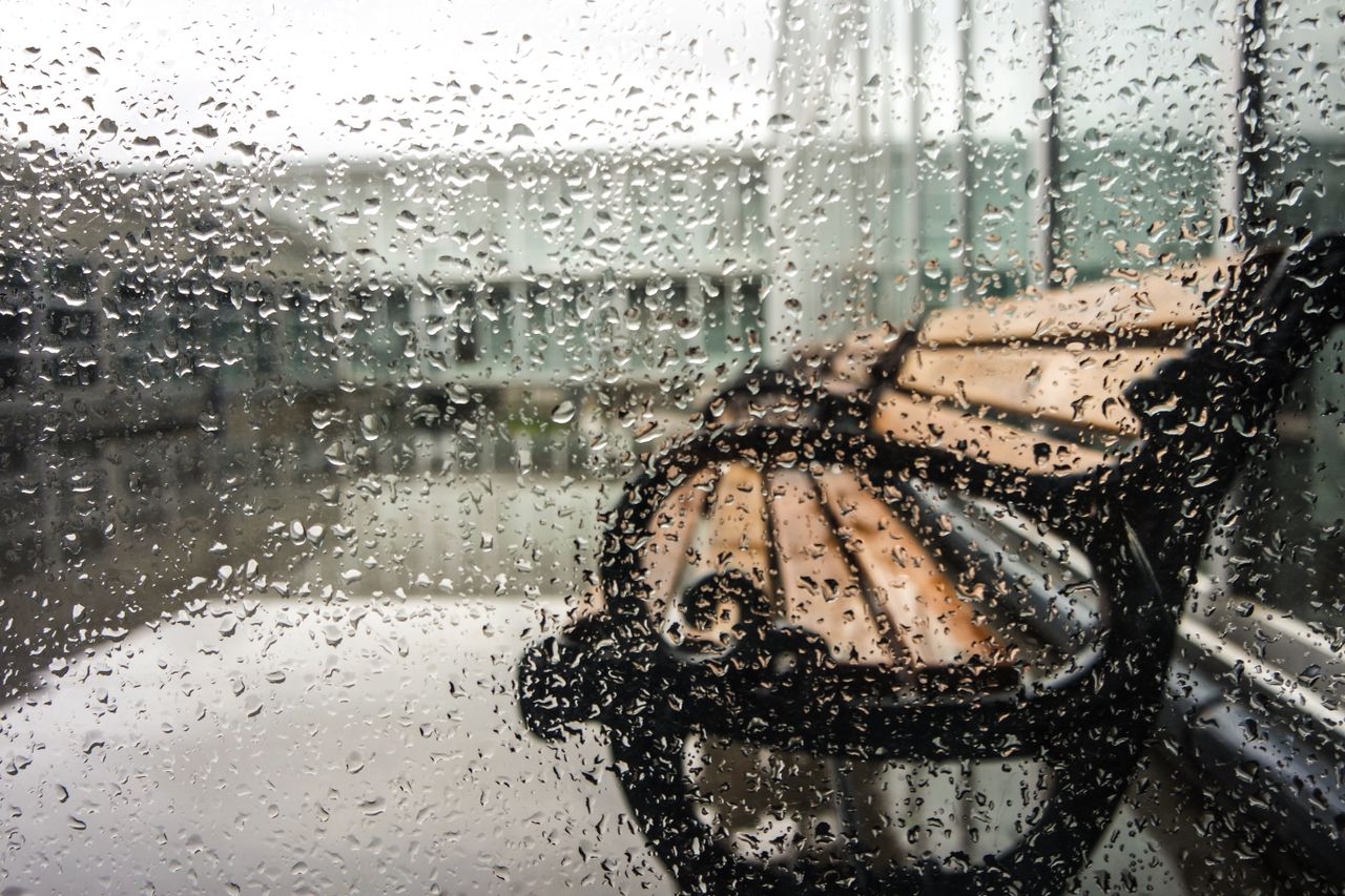 rain soaked window with a view of a bench outside in fatih istanbul tu